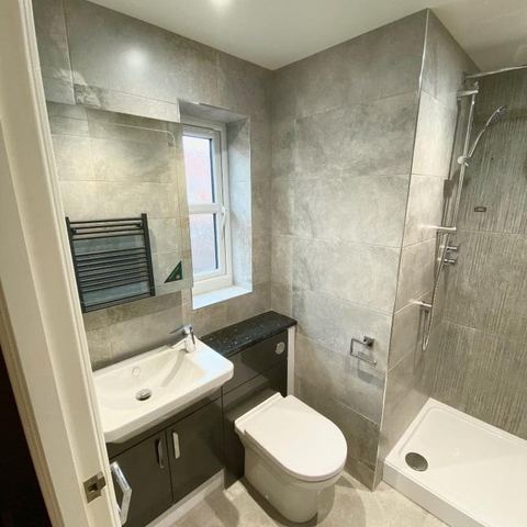 A bright bathroom designed around limited natural light — finished