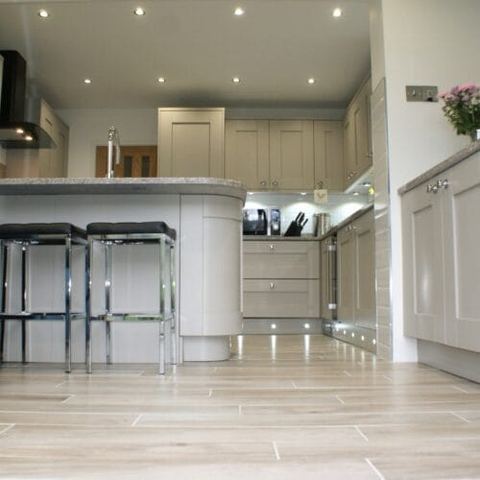 A large kitchen with a seating area and breakfast bar — finished