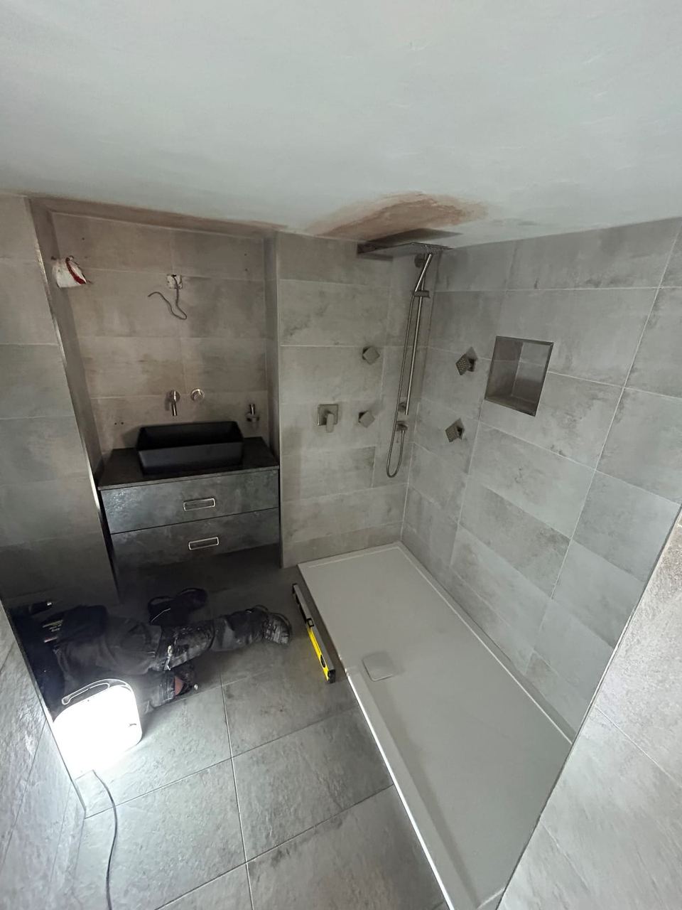 Contemporary apartment bathroom with spa-style storage — finished