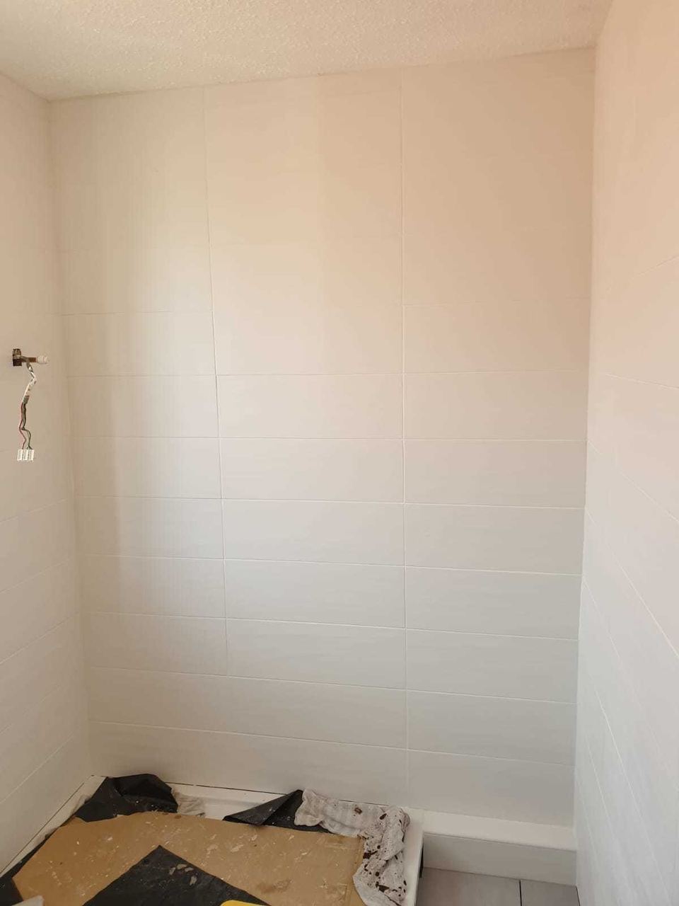 White ceramic tiling to lift a small bathroom — finished