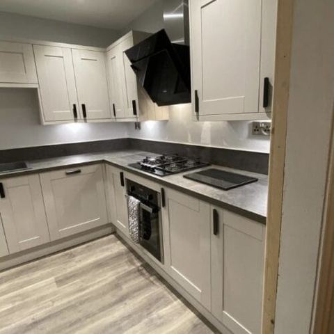 Flooring through a kitchen, dining room and living room — finished