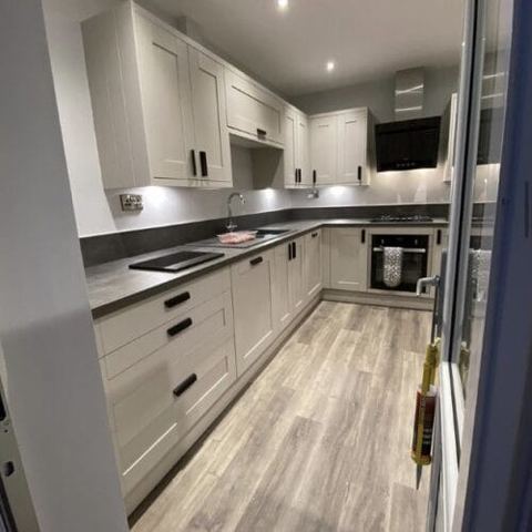Flooring through a kitchen, dining room and living room — finished