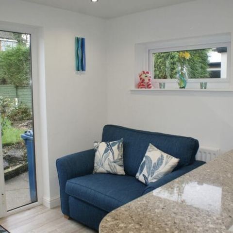 A large kitchen with a seating area and breakfast bar — finished