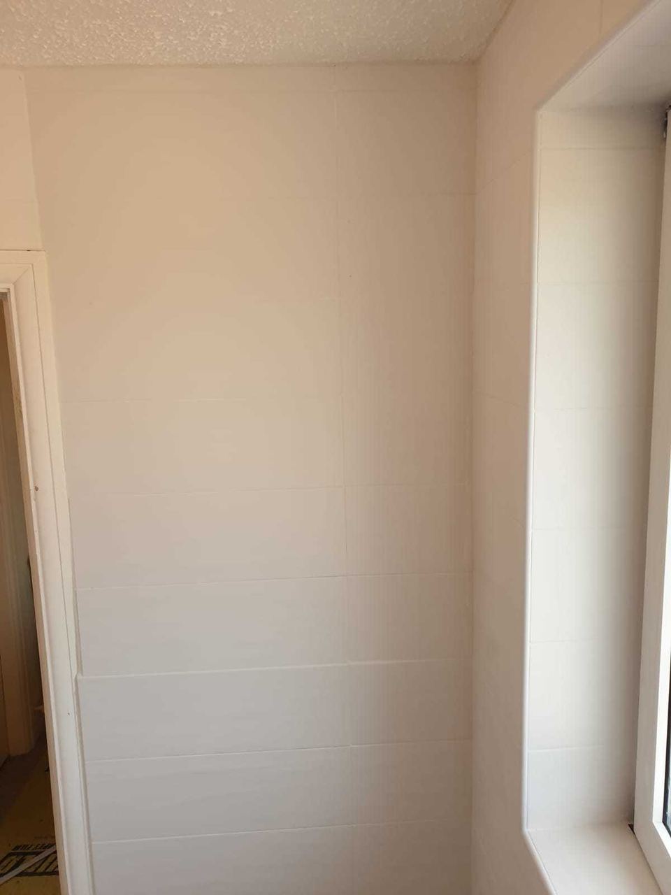 White ceramic tiling to lift a small bathroom — finished