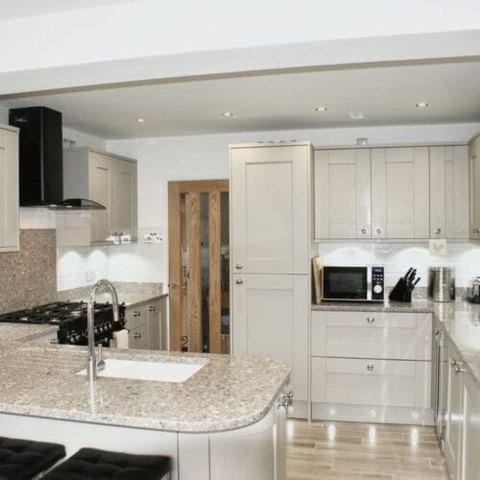 A large kitchen with a seating area and breakfast bar — finished