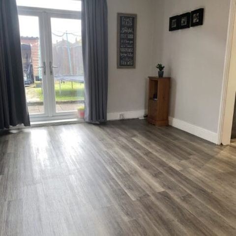 Flooring through a kitchen, dining room and living room — finished