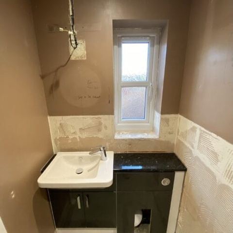 A bright bathroom designed around limited natural light — finished