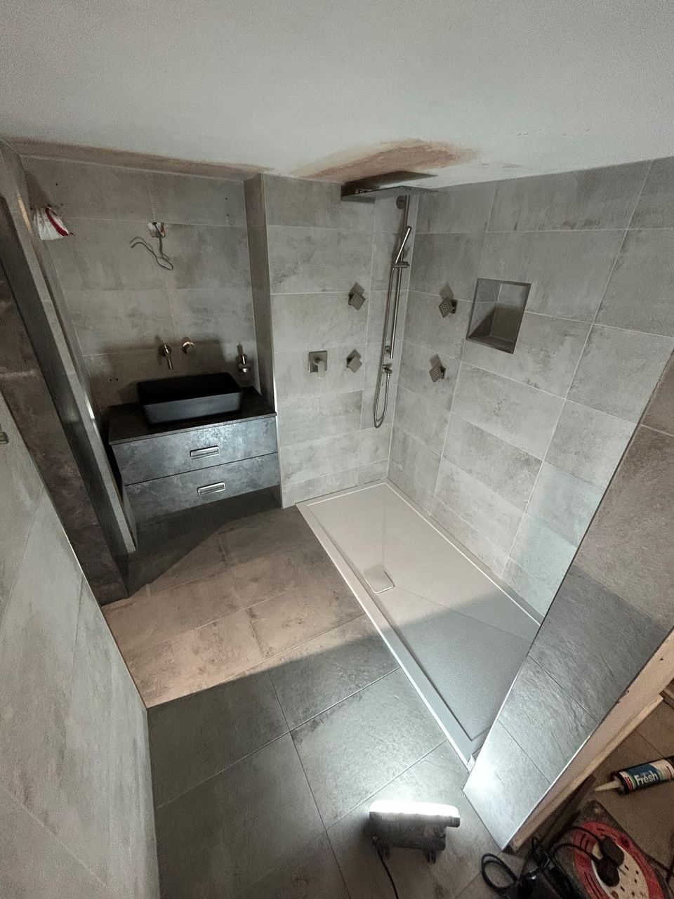Contemporary apartment bathroom with spa-style storage — finished