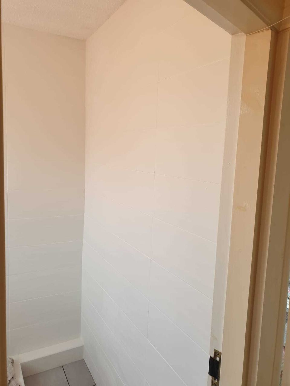 White ceramic tiling to lift a small bathroom — finished