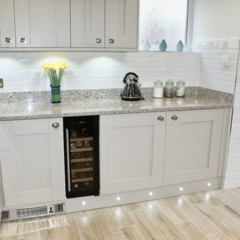 A large kitchen with a seating area and breakfast bar — finished