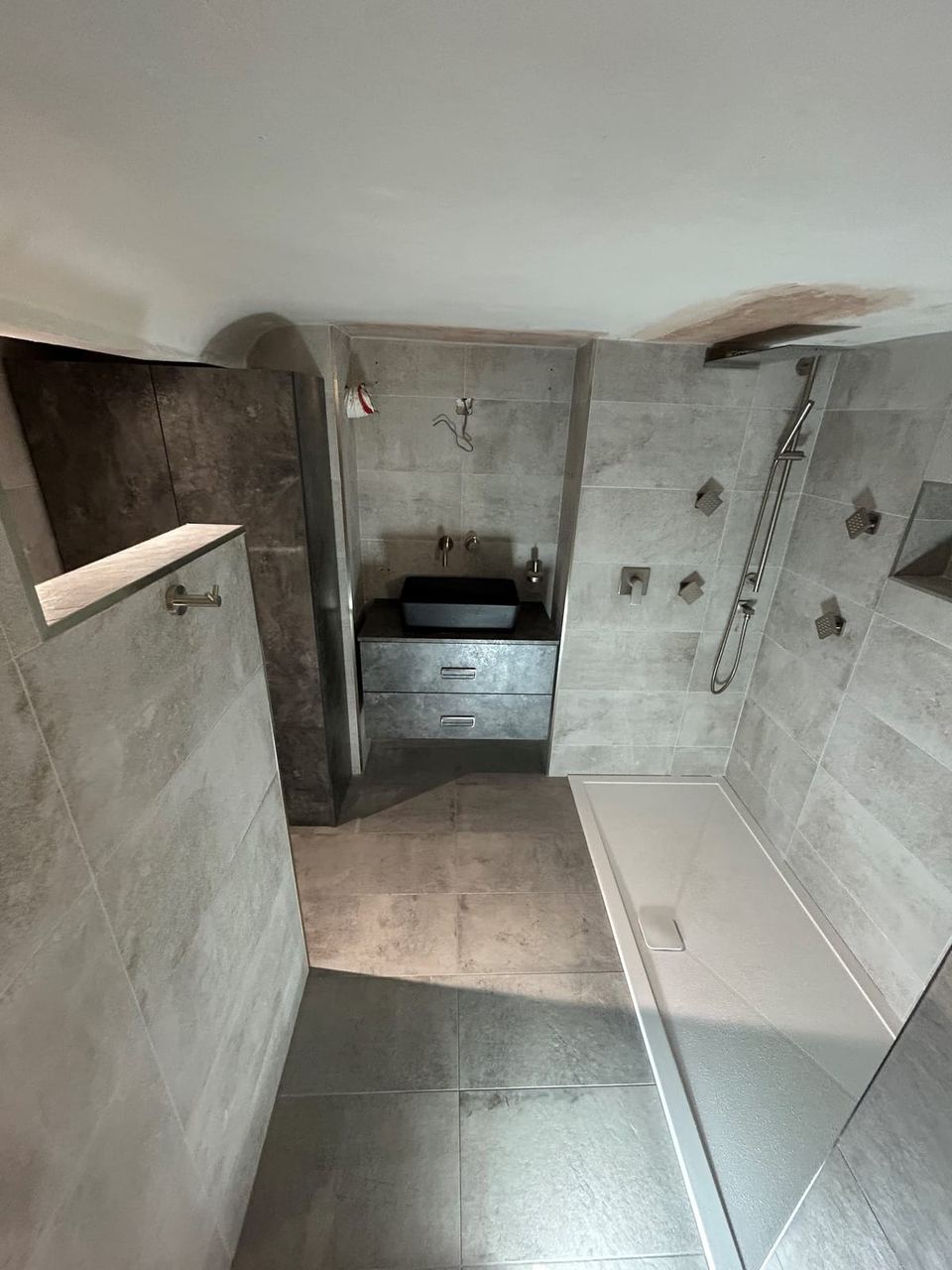 Contemporary apartment bathroom with spa-style storage — finished