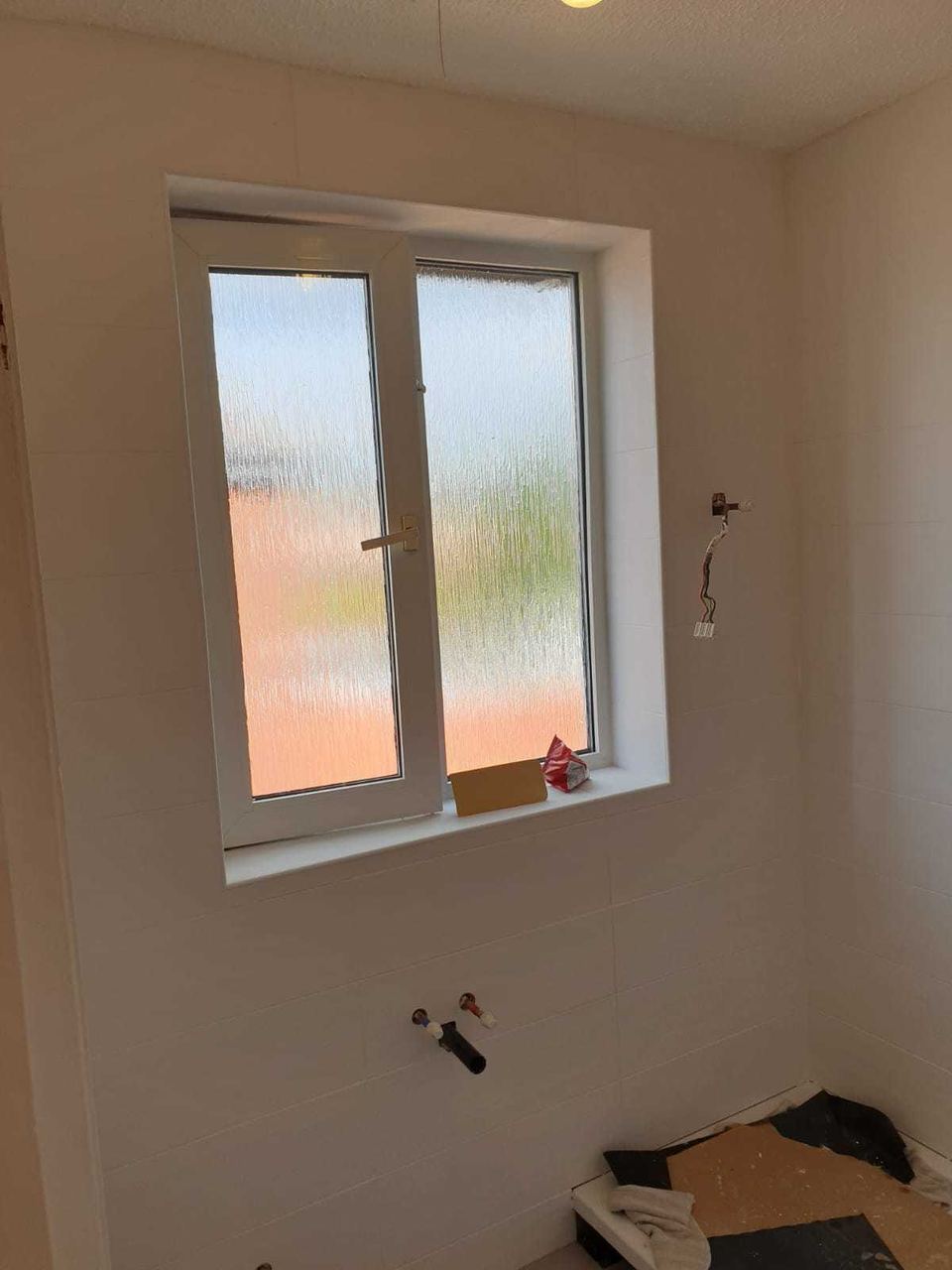 White ceramic tiling to lift a small bathroom — finished