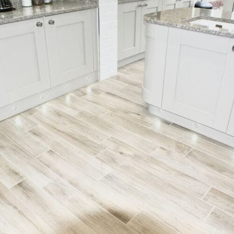 A large kitchen with a seating area and breakfast bar — finished