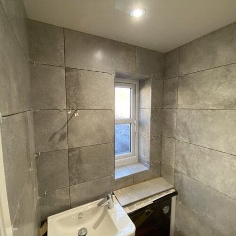 A bright bathroom designed around limited natural light — finished