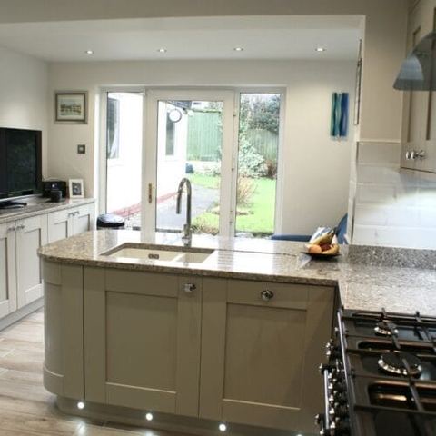 A large kitchen with a seating area and breakfast bar — finished