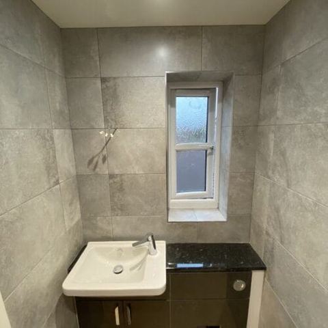 A bright bathroom designed around limited natural light — finished