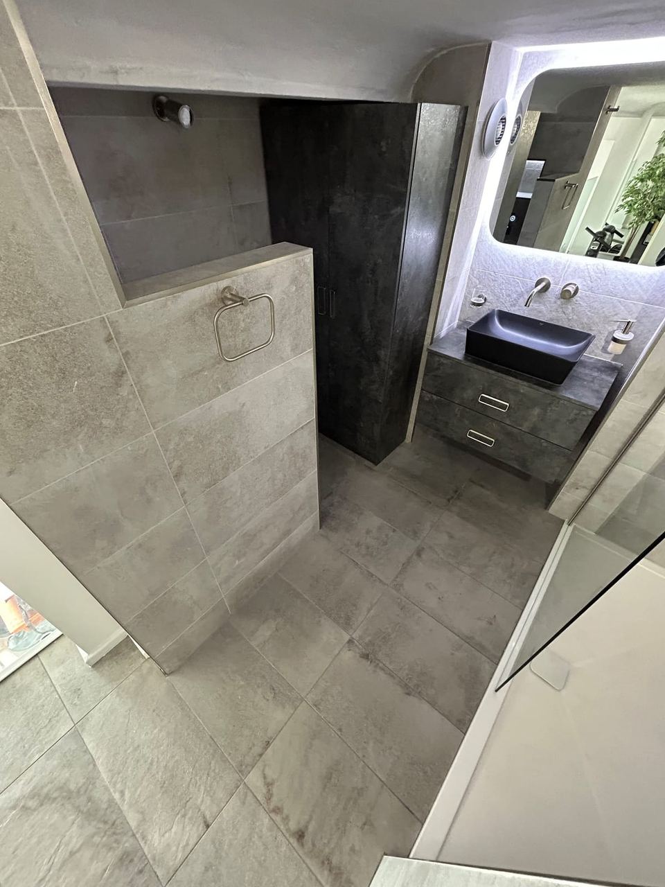 Contemporary apartment bathroom with spa-style storage — finished