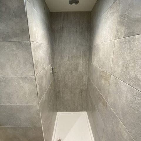 A bright bathroom designed around limited natural light — finished