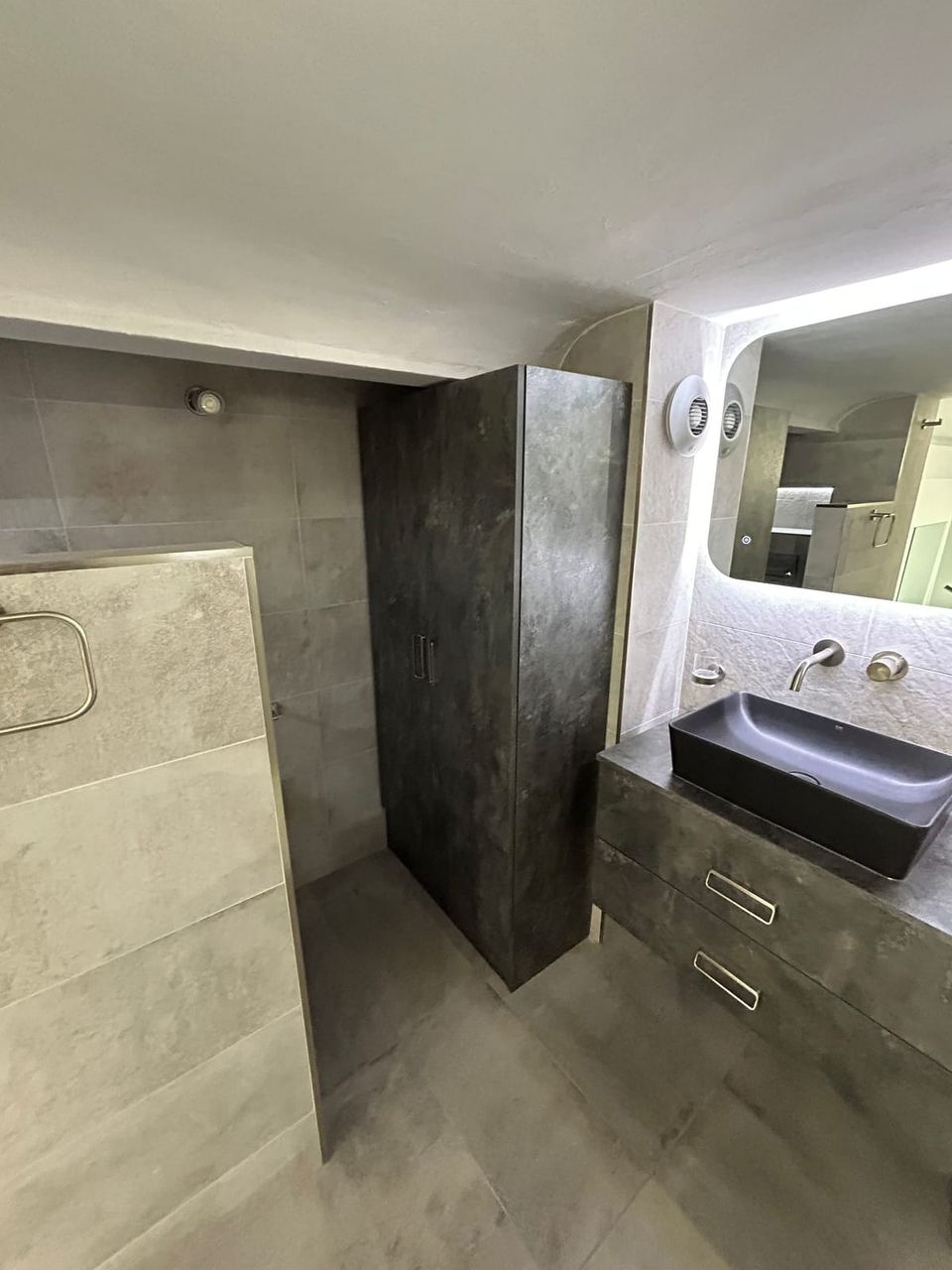Contemporary apartment bathroom with spa-style storage — finished