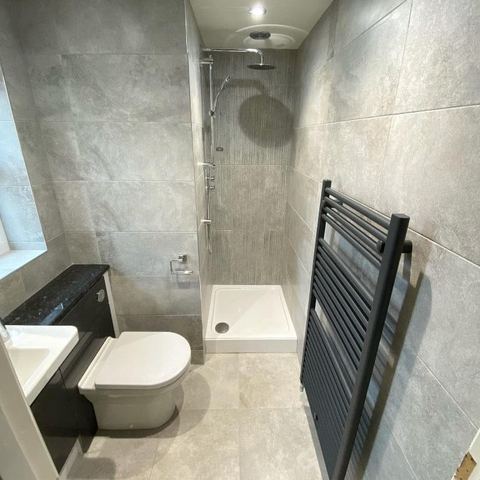 A bright bathroom designed around limited natural light — finished