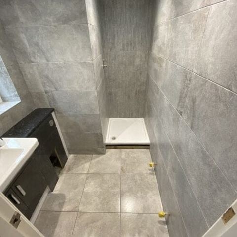 A bright bathroom designed around limited natural light — finished