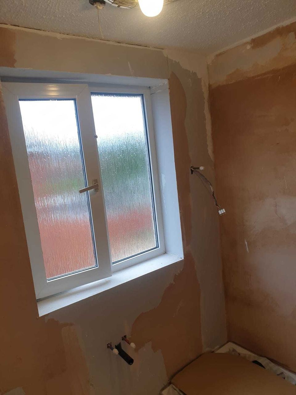 White ceramic tiling to lift a small bathroom — before work started