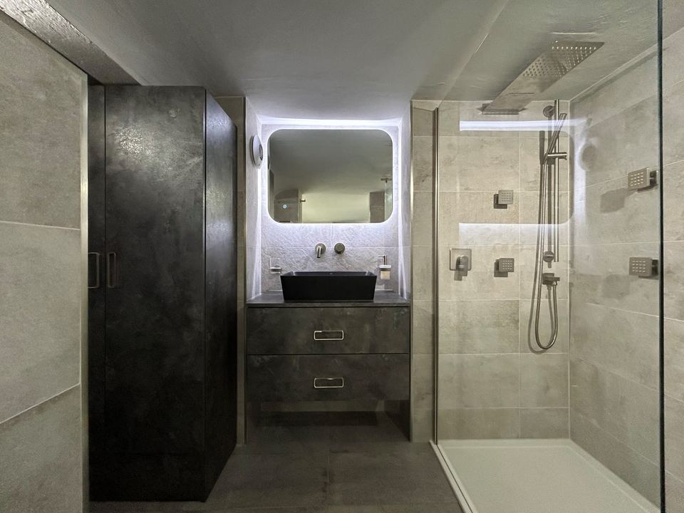 Contemporary apartment bathroom with spa-style storage — finished