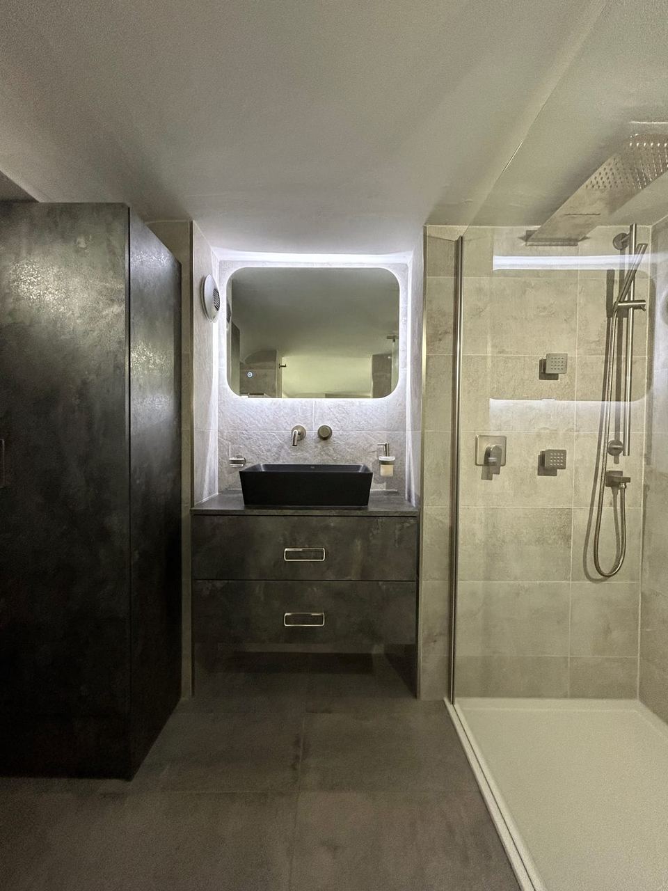 Contemporary apartment bathroom with spa-style storage — finished