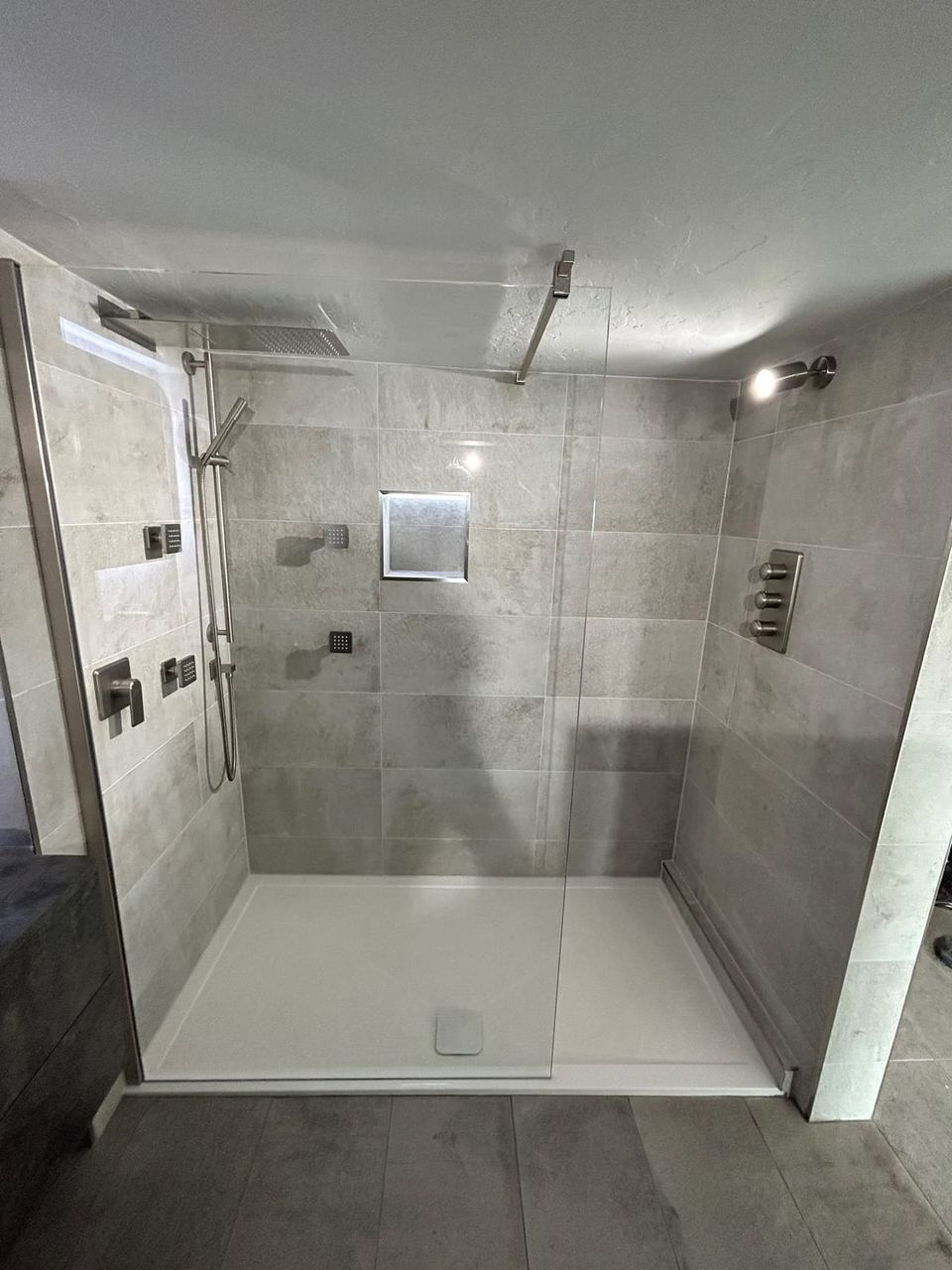 Contemporary apartment bathroom with spa-style storage — finished