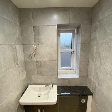 A bright bathroom designed around limited natural light — finished