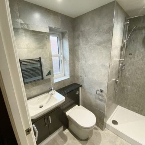A bright bathroom designed around limited natural light — finished