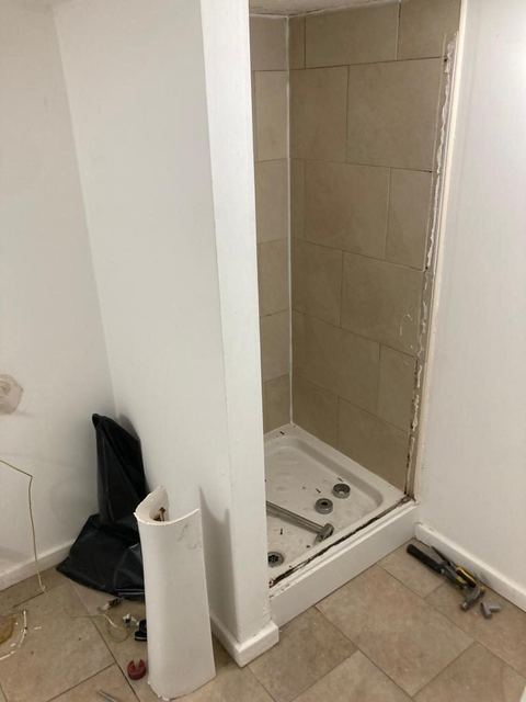 Contemporary apartment bathroom with spa-style storage — before work started