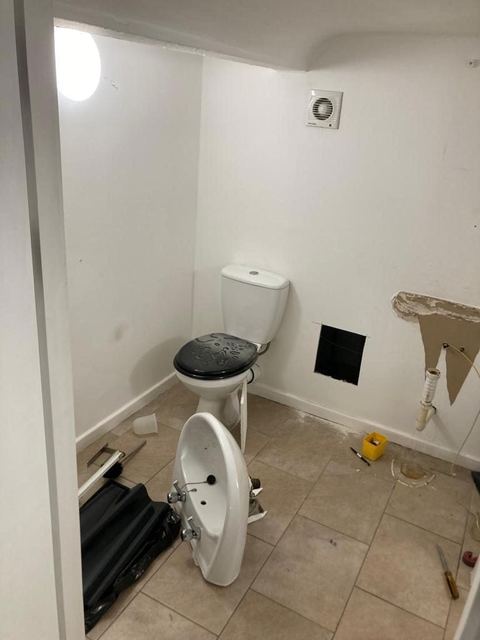 Contemporary apartment bathroom with spa-style storage — before work started
