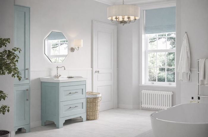 Chelworth vanity in Contour Blue Sage below a chandelier