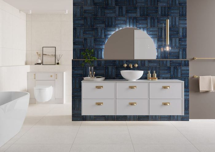 Dartmoor fitted run in Whisper White with navy tiling and a bath