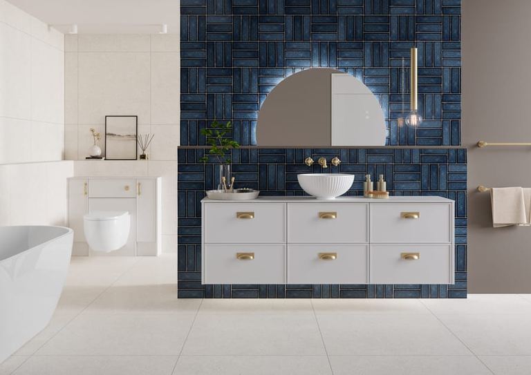 Dartmoor fitted run in Whisper White with navy tiling and a bath