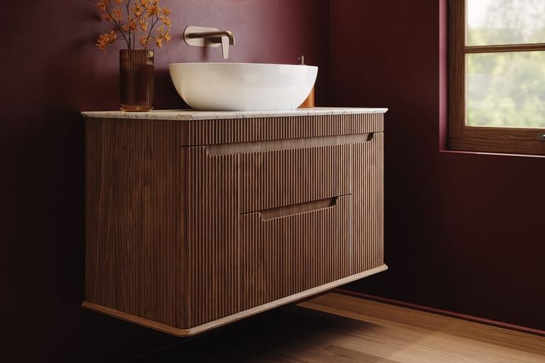 Firova vanity in Persian Walnut against a burgundy wall