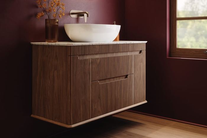 Firova vanity in Persian Walnut against a burgundy wall