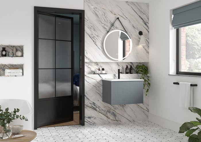 Minori vanity in Aegean Blue with a marble surround and a crittall screen