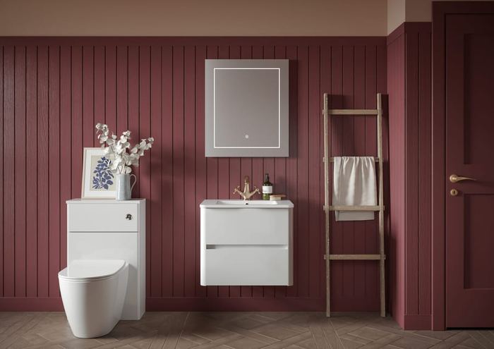 Sora vanity in Pearly White against burgundy panelling