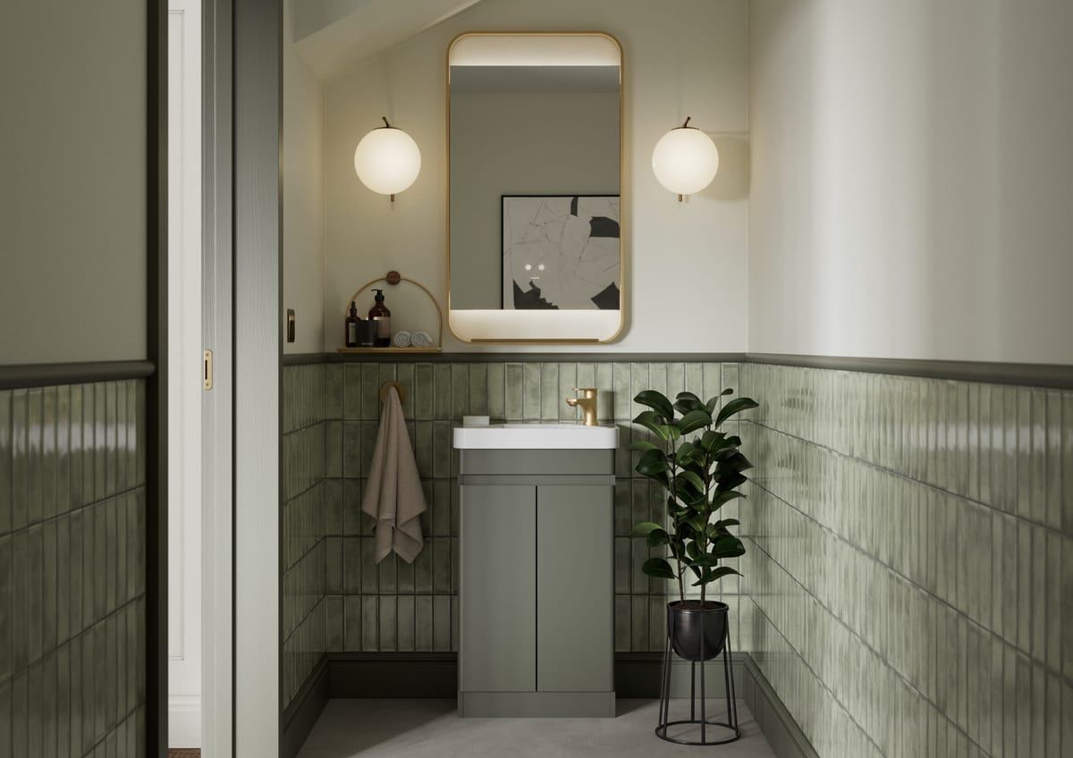 Sora vanity in Warm Sage in an arched alcove with green tiling