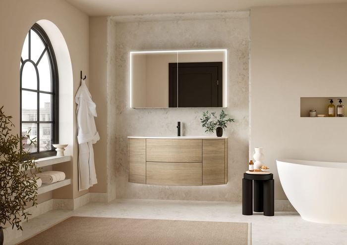 Ultimo curved vanity in Tortona Oak with a freestanding bath and arched window