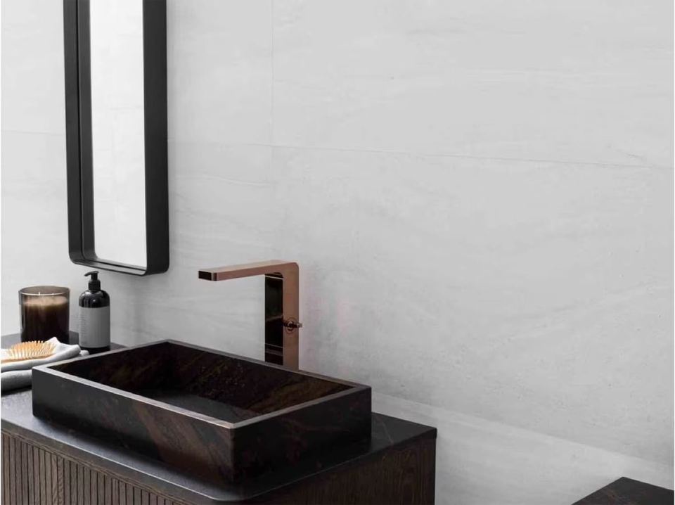 Porcelanosa Butan Bone ceramic tiles fitted in a room, grey, matt