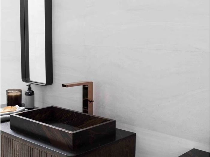 Porcelanosa Butan Bone ceramic tiles fitted in a room, grey, matt