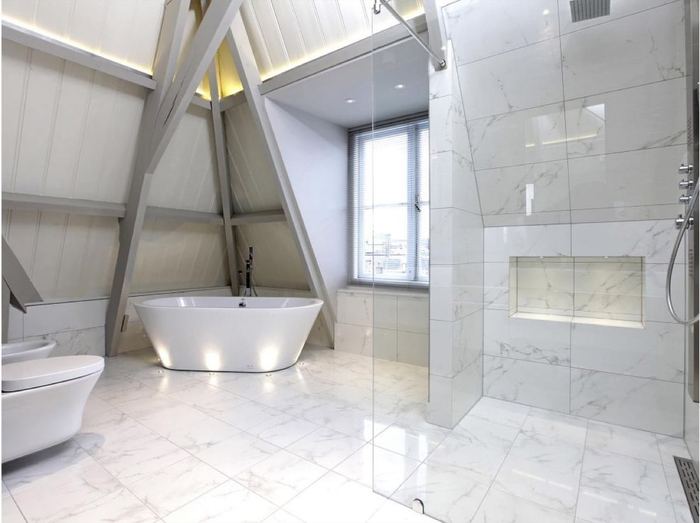 Porcelanosa Carrara Blanco Brillo porcelain tiles fitted in a room, marble-effect, gloss & polished