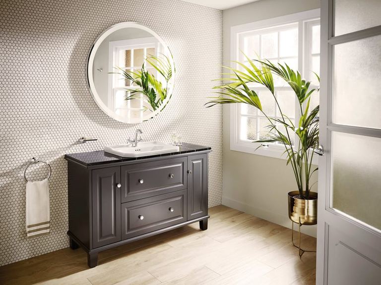 Carmen basin on a dark vanity unit with a round mirror
