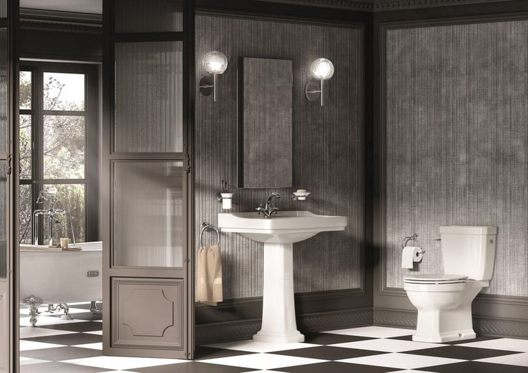 Carmen pedestal basin in a dark panelled room with a chequerboard floor