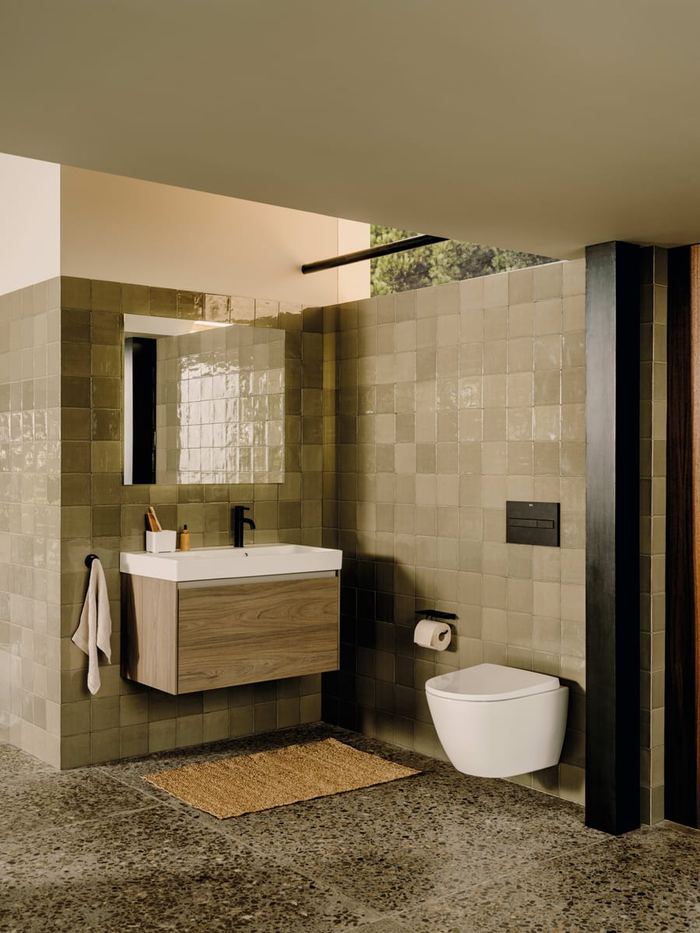 Ona wood-effect unit with a wall-hung WC and green tiling