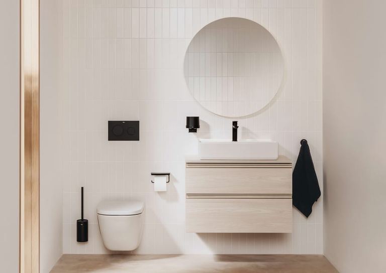 The Gap wall-hung unit with a round mirror, wall-hung WC and black brassware