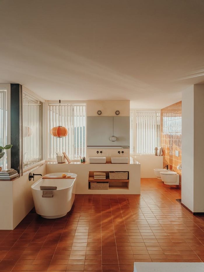 Tura bathroom with a freestanding bath, twin basins and slatted blinds